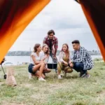 a-company-of-friends-have-a-rest-in-the-camping-free-photo